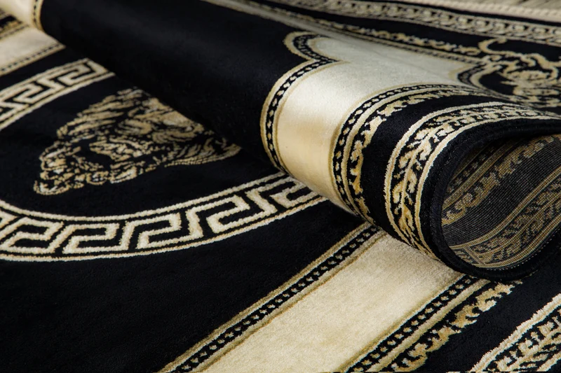 Runder Designer Teppich mit Löwe Mäander Muster in Schwarz Creme Gold