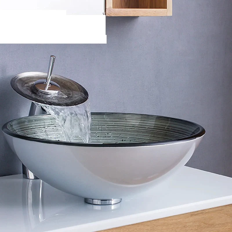 Slick Tempered Glass Vessel Sink With Fly Spiral Pattern And Waterfall Faucet Offers Round Shape Toughened Durability Scratch Proof Surface Easy Wiping Care And Includes Pop Up Drain For A Total Bathroom Glow Up
