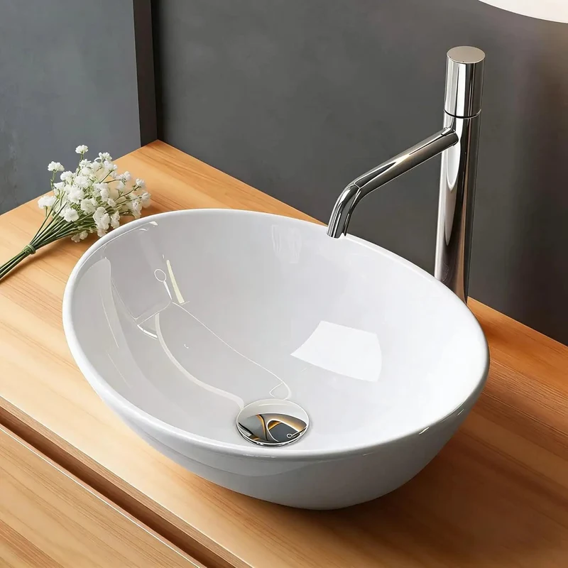 Compact Oval Ceramic Above Counter Sink For Small Bathrooms Boasting A Knockout Washing Bowl Sleek Glazed Finish And No Headache Installation That Slips Into Tight Vanities While Keeping Surfaces Slick And Spotless